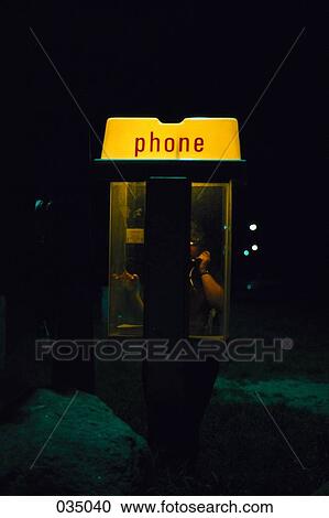 Stock Image - A person in a phone booth. Fotosearch