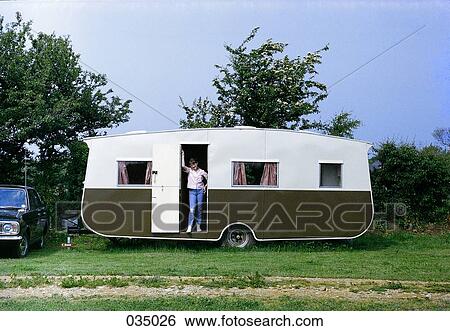 A person standing in the door of a camper View Large Photo Image Stock Photograph - A person standing in the door of a camper. Fotosearch