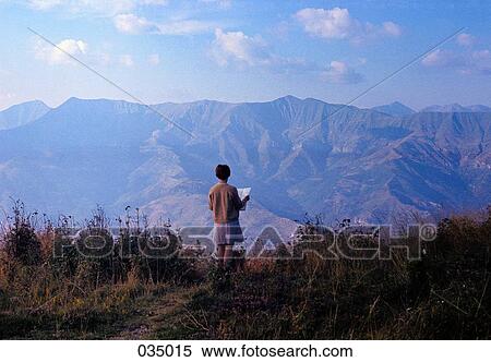 A woman reading, facing the mountains View Large Photo Image Stock Photography - A woman reading, facing the mountains. Fotosearch