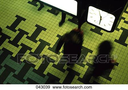 People walking below a clock View Large Photo Image Stock Photo - People walking below a clock. Fotosearch