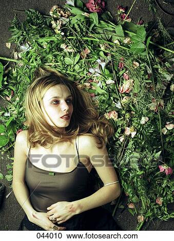 A woman lying on a pile of flowers View Large Photo Image Stock Image - A woman lying on a pile of flowers. Fotosearch