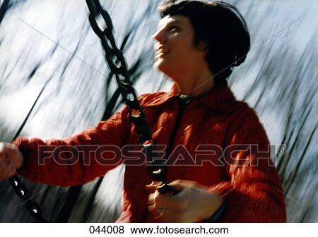 Stock Photo - A woman swinging. Fotosearch