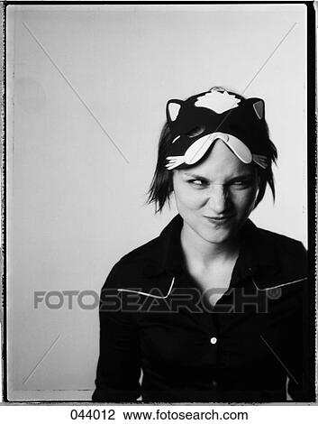 A woman with a cat mask on her head making a funny face View Large Photo Image Stock Image - A woman with a cat mask on her head making a funny face. Fotosearch