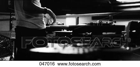 A person next to turntables View Large Photo Image Stock Photograph - A person next to turntables. Fotosearch