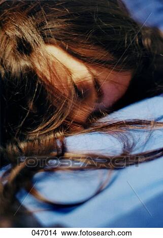 A woman sleeping with her hair covering her face View Large Photo Image Picture - A woman sleeping with her hair covering her face. Fotosearch