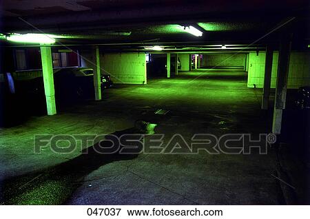 Stock Photo - An empty, dark underground parking garage. Fotosearch