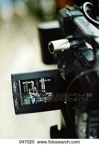 Stock Image - Film on the screen of a digital video camera. Fotosearch