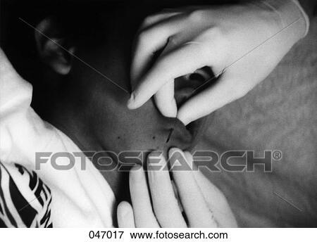 Gloved hands making a piercing in a person's lip View Large Photo Image Stock Photo - Gloved hands making a piercing in a person's lip. Fotosearch