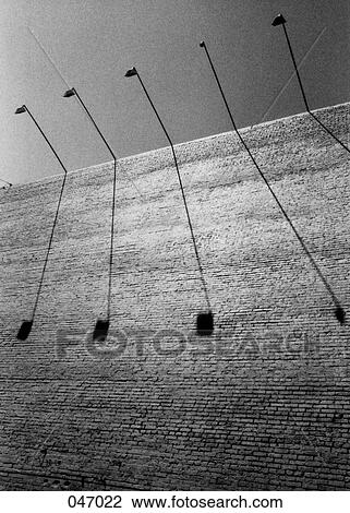 Shadows of light posts on a brick wall View Large Photo Image Stock Image - Shadows of light posts on a brick wall. Fotosearch
