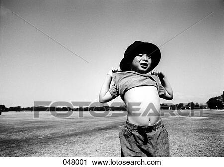 boy pulling shirt up View Large Photo Image Stock Image - boy pulling shirt up. Fotosearch