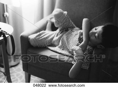 boy resting in a chair View Large Photo Image Stock Image - boy resting in a chair. Fotosearch