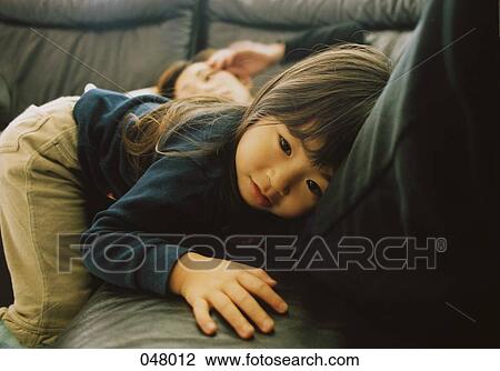 Daughter resting next to mother View Large Photo Image Stock Image - Daughter resting next to mother. Fotosearch