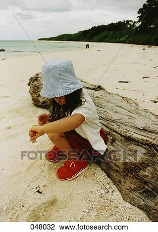 girl playing in sand on a beach View Large Photo Image Stock Image - girl playing in sand on a beach. Fotosearch