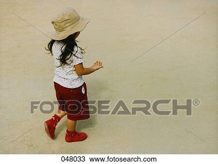 girl walking on a sandy beach View Large Photo Image Stock Image - girl walking on a sandy beach. Fotosearch