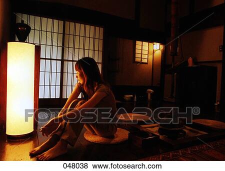 Stock Photo - Japan, woman sitting in a hotel room. Fotosearch