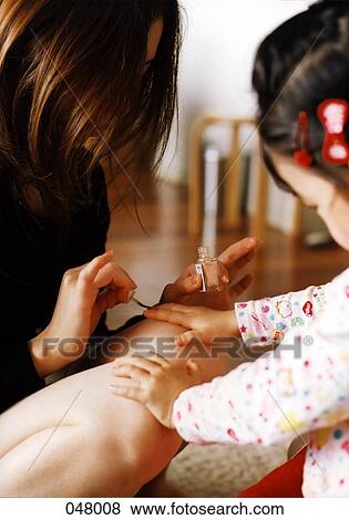 mother painting daughter's fingernails View Large Photo Image Stock Photo - mother painting daughter's fingernails. Fotosearch