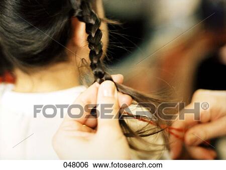 woman braiding girl's hair View Large Photo Image Stock Photograph - woman braiding girl's hair. Fotosearch