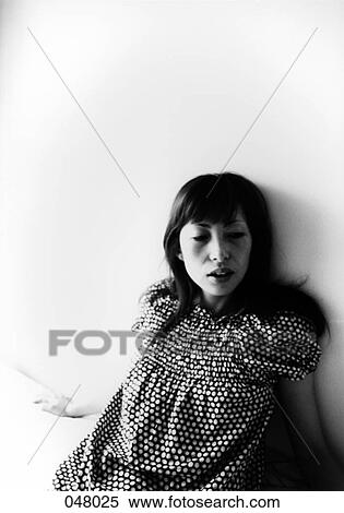 woman sitting on a bed View Large Photo Image Stock Photography - woman sitting on a bed. Fotosearch