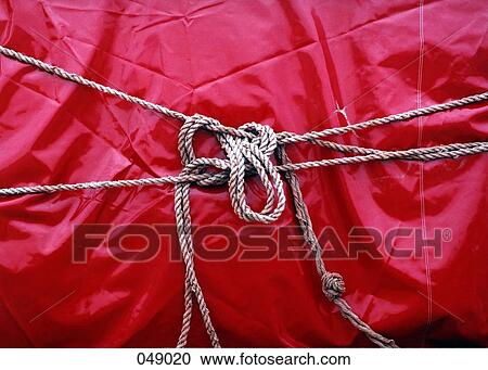 red plastic tied with rope View Large Photo Image Stock Image - red plastic tied with rope. Fotosearch