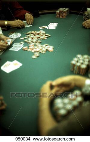 Picture - group of people gambling at a casino blackjack table. Fotosearch