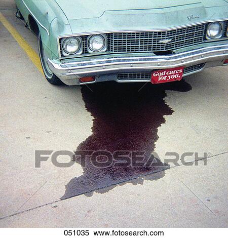 Stock Photography - A car leaking fluid onto the pavement. Fotosearch