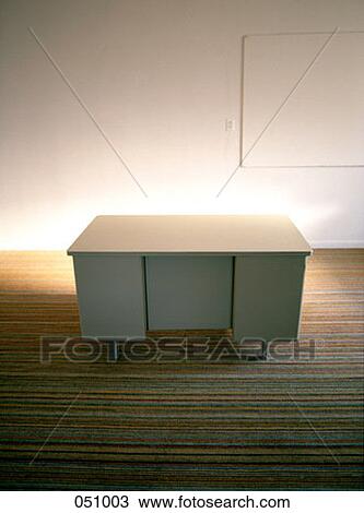 A desk on a carpet in an empty room View Large Photo Image Stock Image - A desk on a carpet in an empty room. Fotosearch