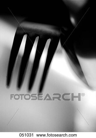 A fork resting on a table View Large Photo Image Stock Image - A fork resting on a table. Fotosearch