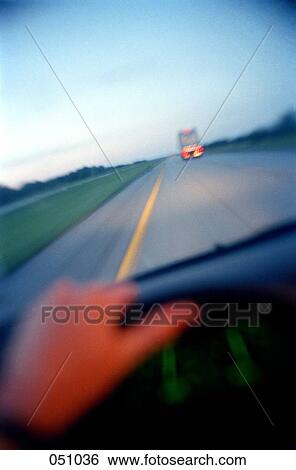 Stock Photograph - A person driving on a highway. Fotosearch