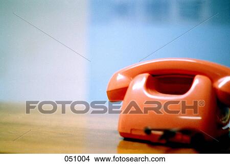 A retro telephone resting on a table View Large Photo Image Picture - A retro telephone resting on a table. Fotosearch