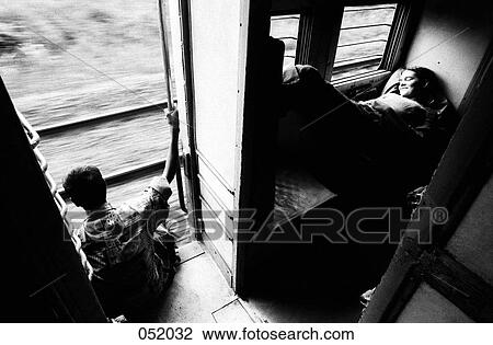 A couple travelling on a train View Large Photo Image Stock Image - A couple travelling on a train. Fotosearch