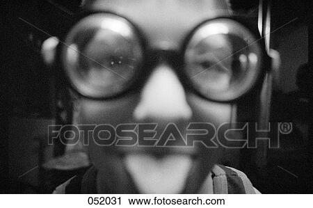 A teenager wearing funny glasses sticks his tongue out View Large Photo Image Stock Image - A teenager wearing funny glasses sticks his tongue out. Fotosearch