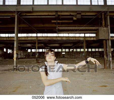 A woman dancing in front of an industrial construction site View Large Photo Image Stock Photograph - A woman dancing in front of an industrial construction site. Fotosearch