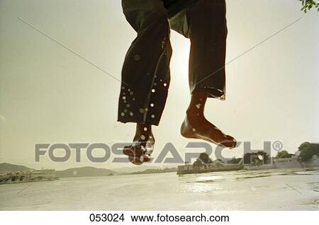 A person's legs jumping into water View Large Photo Image Picture - A person's legs jumping into water. Fotosearch
