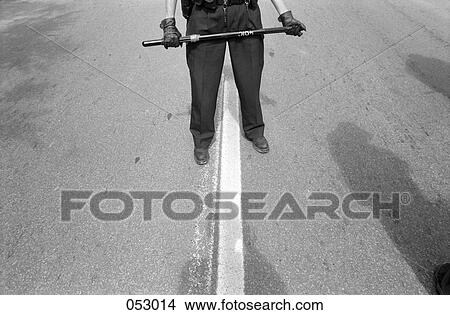 A policeman holding a baton View Large Photo Image Picture - A policeman holding a baton. Fotosearch