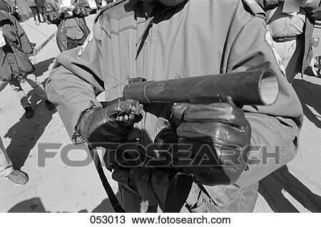 A riot policeman holding a tear gas launcher View Large Photo Image Stock Image - A riot policeman holding a tear gas launcher. Fotosearch