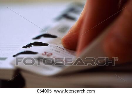 A hand flipping through a datebook View Large Photo Image Stock Photography - A hand flipping through a datebook. Fotosearch