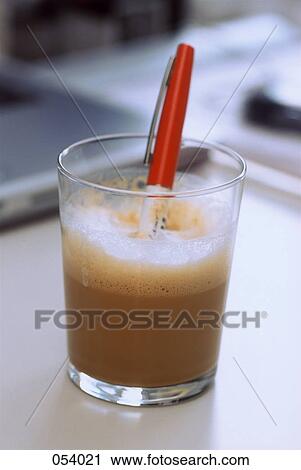 Stock Image - A pen in a glass of coffee. Fotosearch