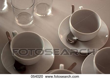 Stock Image - Cups set out on a table. Fotosearch