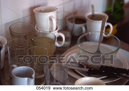 Dirty dishes next to a sink View Large Photo Image Stock Photo - Dirty dishes next to a sink. Fotosearch