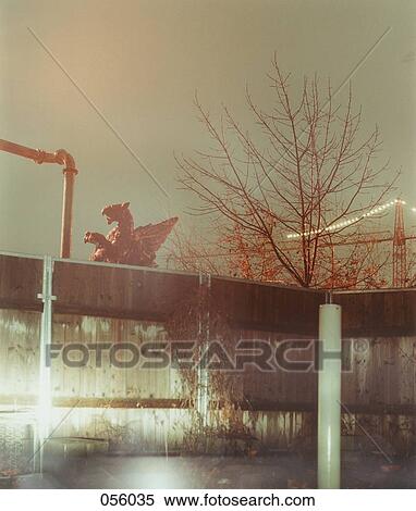 A statue behind a wall View Large Photo Image Stock Photography - A statue behind a wall. Fotosearch