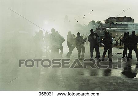 Rioters throwing stones at police View Large Photo Image Stock Image - Rioters throwing stones at police. Fotosearch