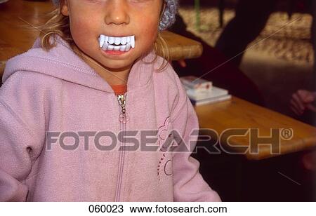 A child wearing fake vampire teeth View Large Photo Image Stock Image - A child wearing fake vampire teeth. Fotosearch