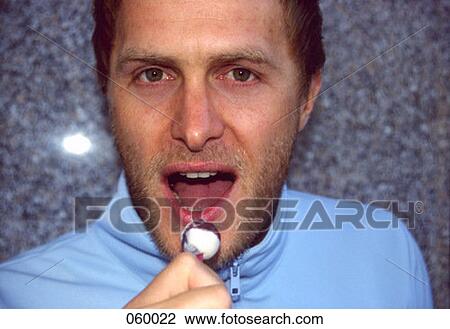 A man holding a lollipop View Large Photo Image Stock Image - A man holding a lollipop. Fotosearch