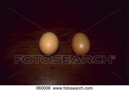 Stock Photo - A plastic egg with a real egg. Fotosearch