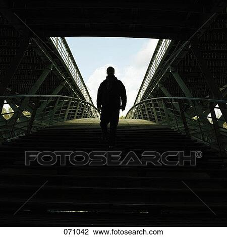 A man walking into a stadium View Large Photo Image Stock Image - A man walking into a stadium. Fotosearch