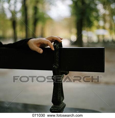 A person's hand on a bench View Large Photo Image Stock Image - A person's hand on a bench. Fotosearch