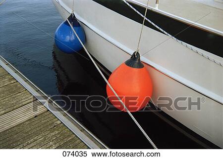 Stock Photography - Two buoys tied to a boat. Fotosearch