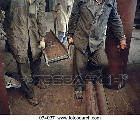 Workmen carrying a beam View Large Photo Image Stock Photo - Workmen carrying a beam. Fotosearch