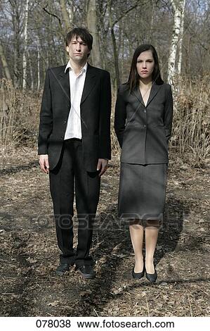 A businessman and a businesswoman standing in a wooded area View Large Photo Image Stock Photo - A businessman and a businesswoman standing in a wooded area. Fotosearch