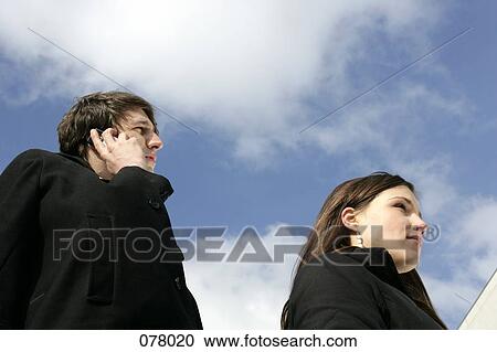 A businessman on a cell phone and a business woman looking ahead View Large Photo Image Stock Image - A businessman on a cell phone and a business woman looking ahead. Fotosearch